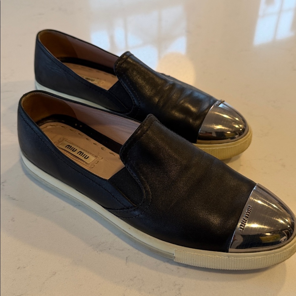 Miu Miu Black Slip-Ons with Metallic Silver Toe